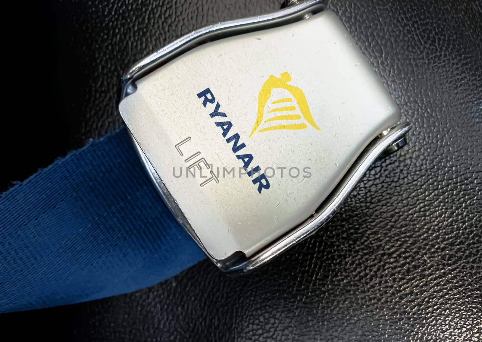 Dublin, IR Jan 2023: detail of the buckle of the seat belt with Ryanair logo on an empty seat. Ryanair is an Irish low-cost airline. Illustrative editorial.