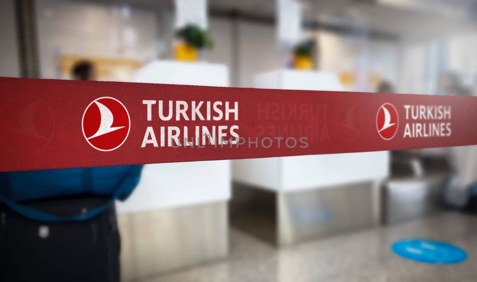Istanbul, TR Jan 2023: Red retractable belt barrier with white Turkish Airlines logo. Turkish Airlines is the turkish flag carrier airline. Travel and airport security. Illustrative editorial