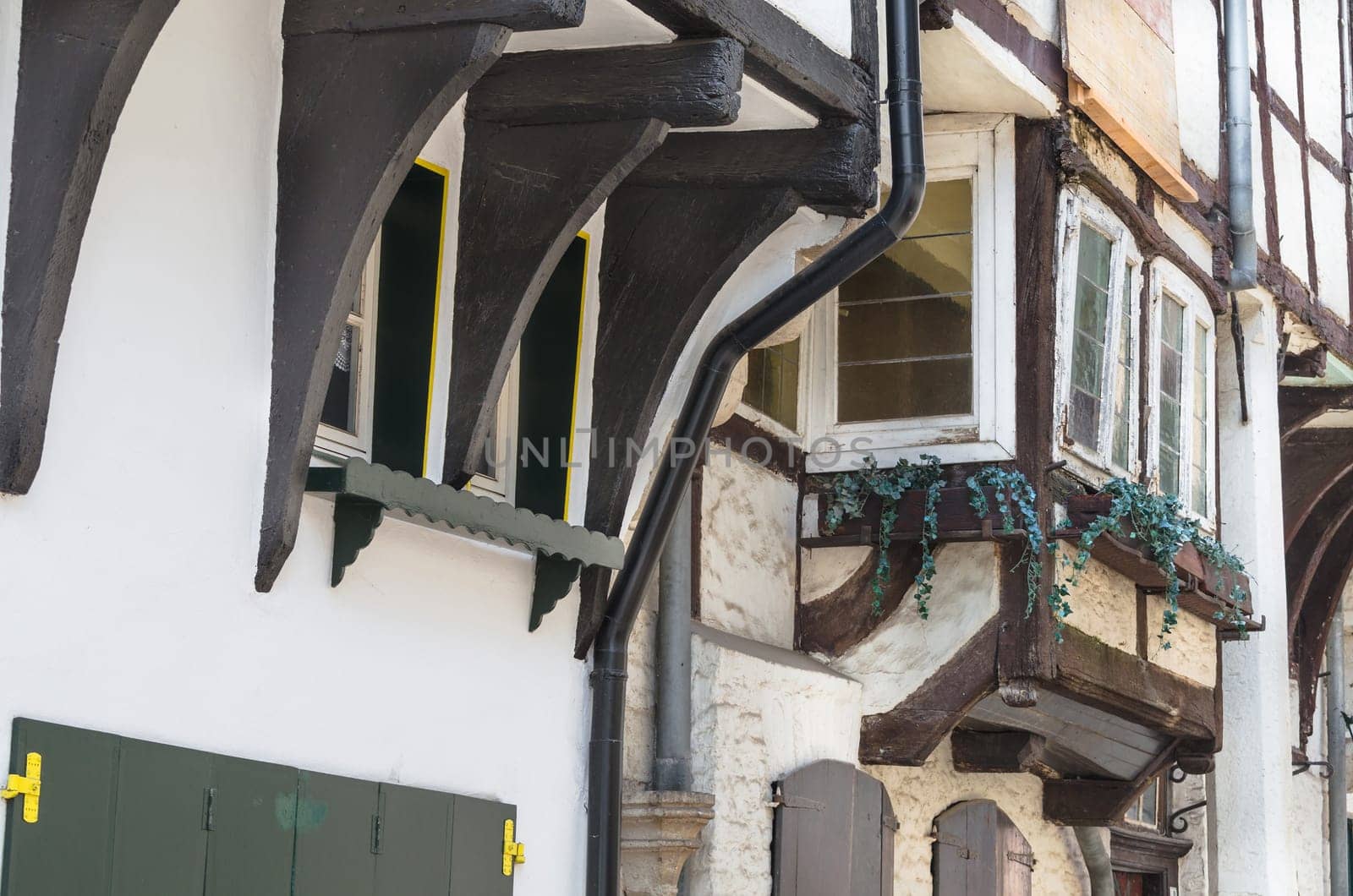 Old half-timbered wall of a historic half-timbered house in a city in Germany.