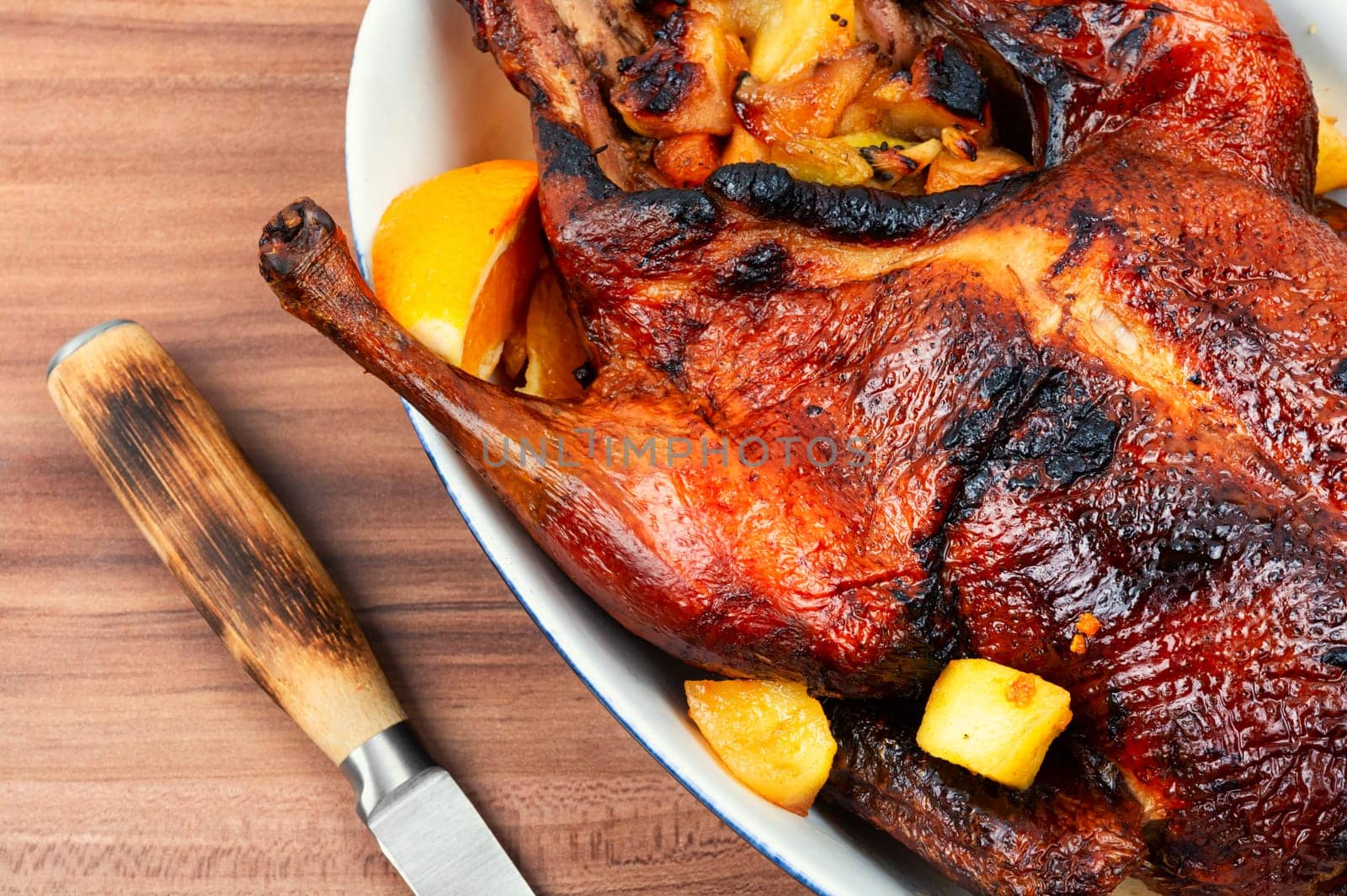 Tasty duck baked with oranges and caramelized apples. Christmas roast goose