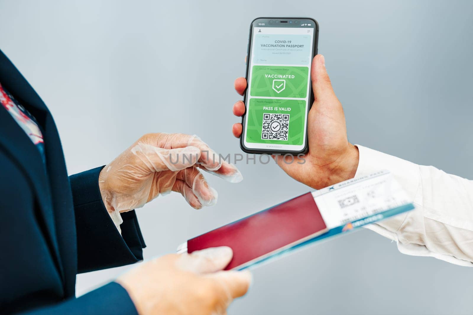 Digital covid certificate. Covid vaccination digital pass. Woman passenger holding digital medical pass on her mobile phone, passport and airplane ticket. Traveler showing digital covid test result as medical pass for travel during covid-19 pandemic