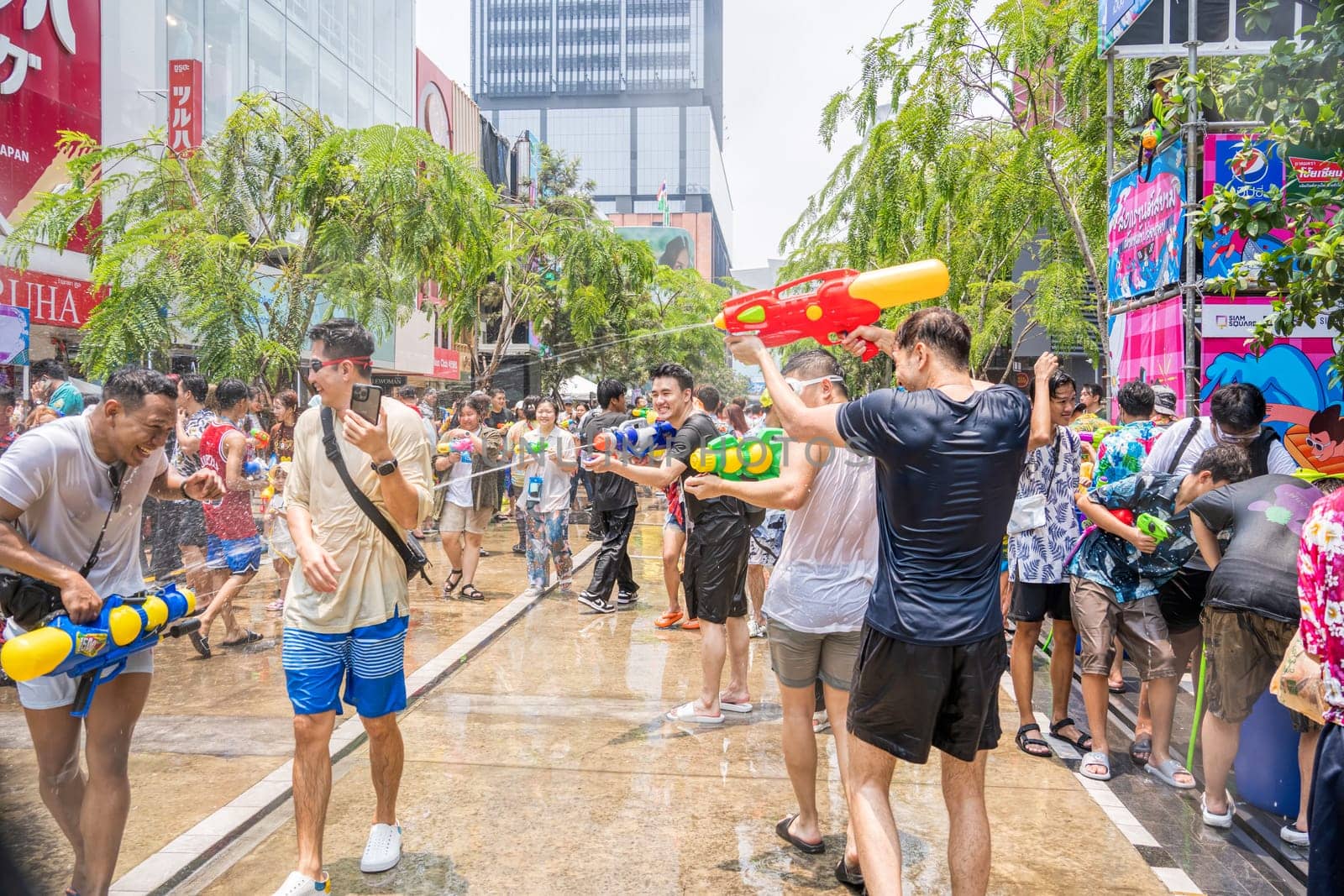 Siam Square, Bangkok, Thailand - APR 13, 2023 Songkran Festival, The short action of people joins celebrations of the Thai New Year or Songkran in Siam Square Bangkok, Thailand.