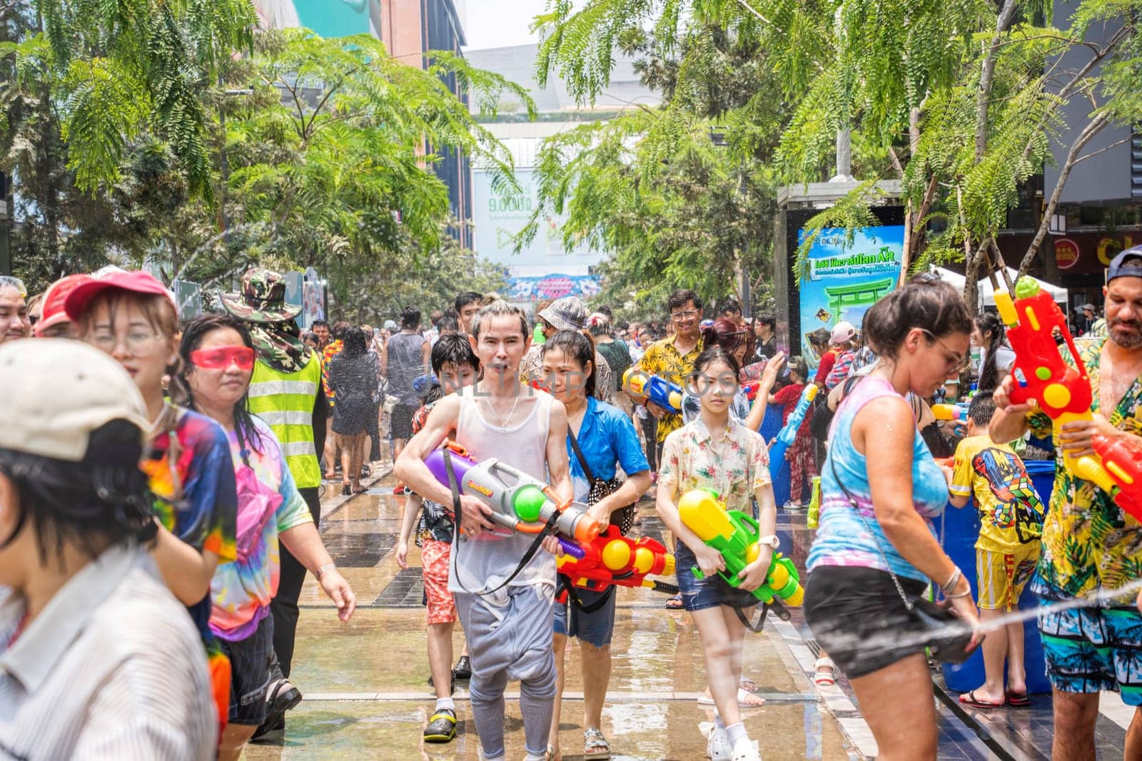 Siam Square, Bangkok, Thailand - APR 13, 2023 Songkran Festival, The short action of people joins celebrations of the Thai New Year or Songkran in Siam Square Bangkok, Thailand.