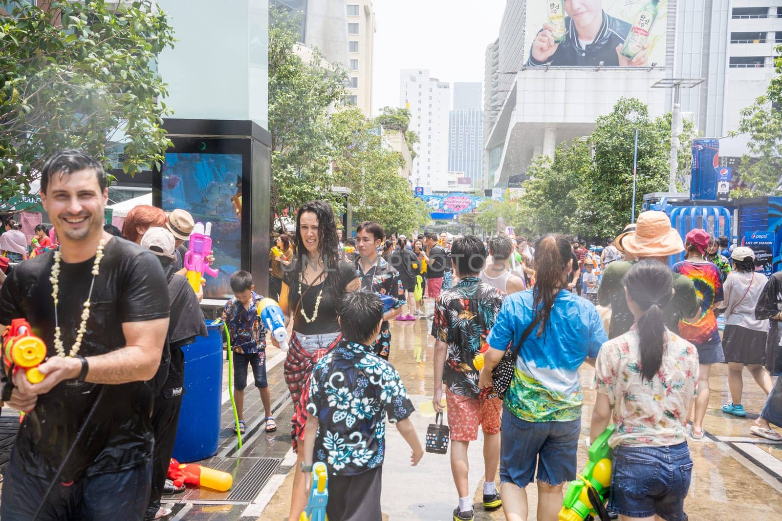 Siam Square, Bangkok, Thailand - APR 13, 2023 Songkran Festival, The short action of people joins celebrations of the Thai New Year or Songkran in Siam Square Bangkok, Thailand.