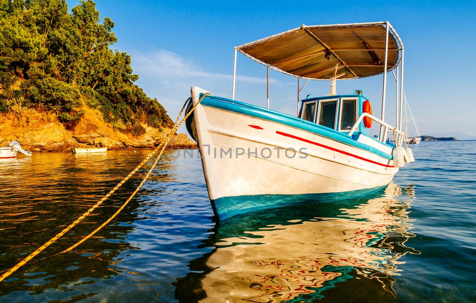 Traditional colorful boats in old town of Skiathos island, Sporades, Greece. Scenic view of aegean sea. Popular summer holiday destination scene.
