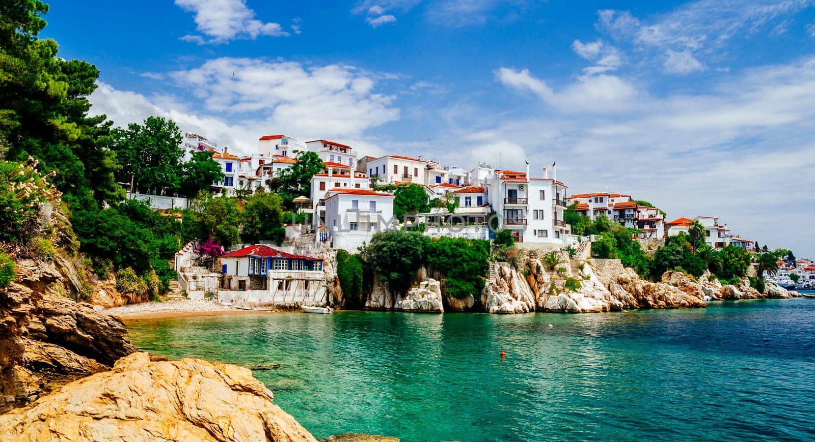 Old town view of Skiathos island, Sporades, Greece. Greek traditional architecture and aegean sea. Popular summer holiday destination scene.