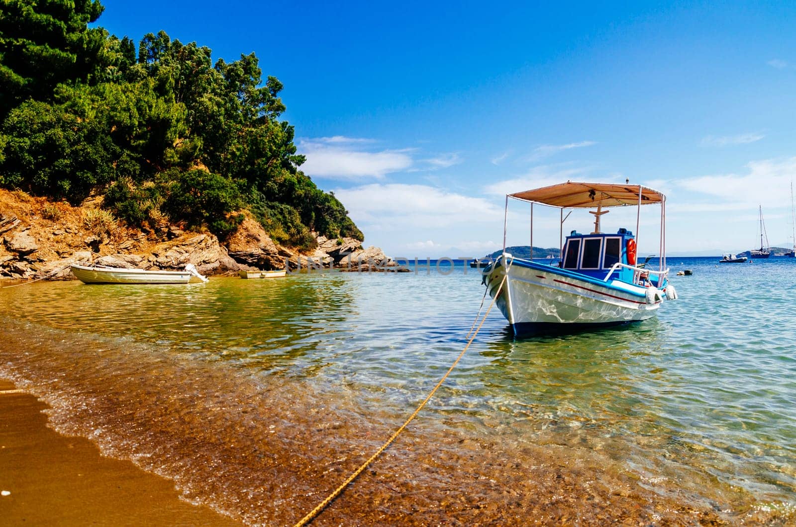 Traditional colorful boats in old town of Skiathos island, Sporades, Greece. Scenic view of aegean sea. Popular summer holiday destination scene.