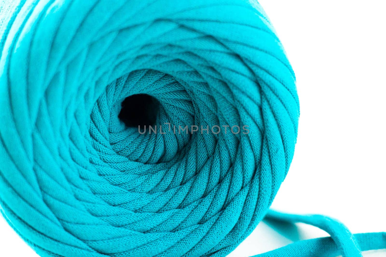 Skein of turquoise knitted yarn, isolated on white background