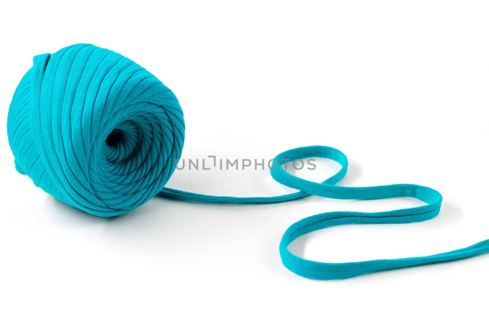 Skein of turquoise knitted yarn, isolated on white background