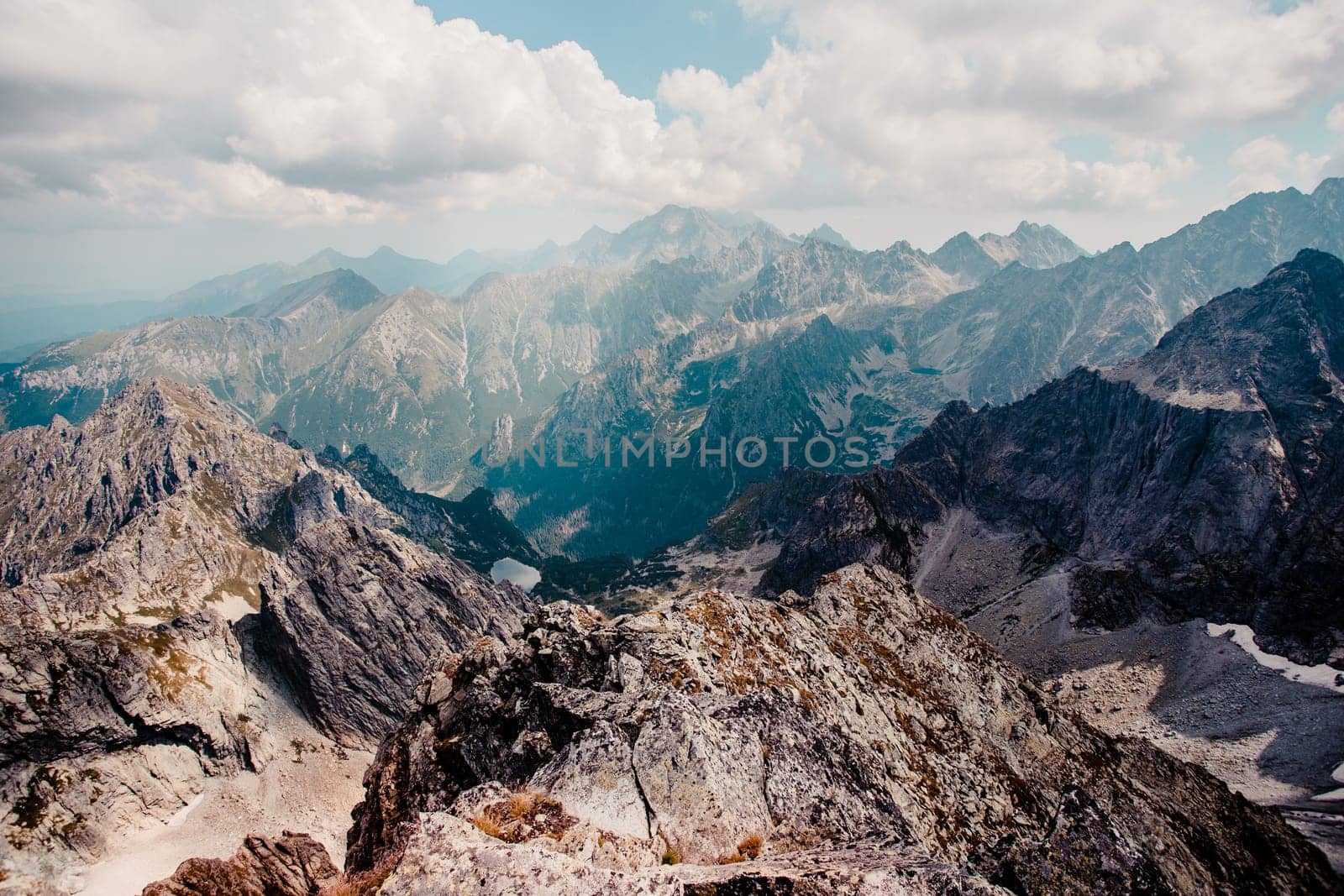 Landscape of mountain peaks, scenery from high summit on wide valley and rough mountain range in the Tatra Mountains