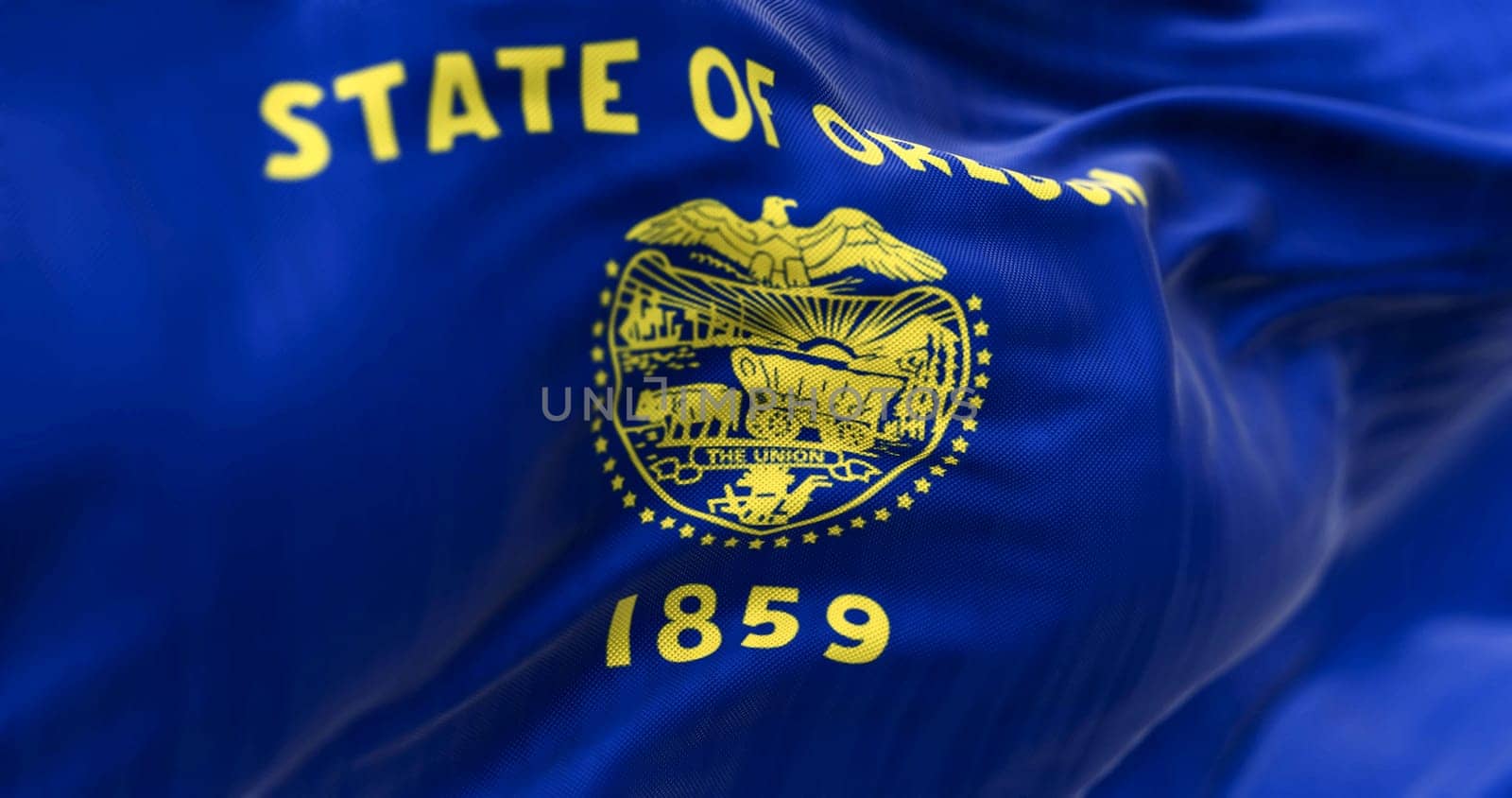 Close-up of the Oregon state flag waving. The Oregon flag is two-sided with navy blue and gold colors. Selective focus. 3d illustration render. Fluttering fabric. Textured background