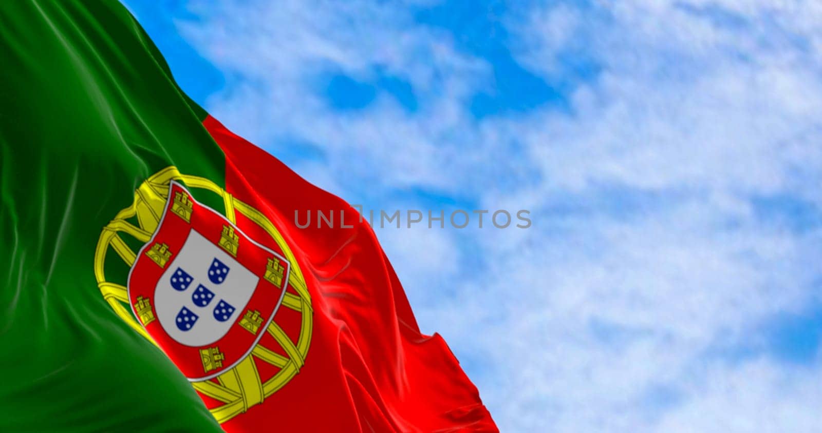 Portugal national flag waving in the wind on a clear day. Portuguese Republic is a Member State of the European Union. 3d illustration render. Fluttering fabric