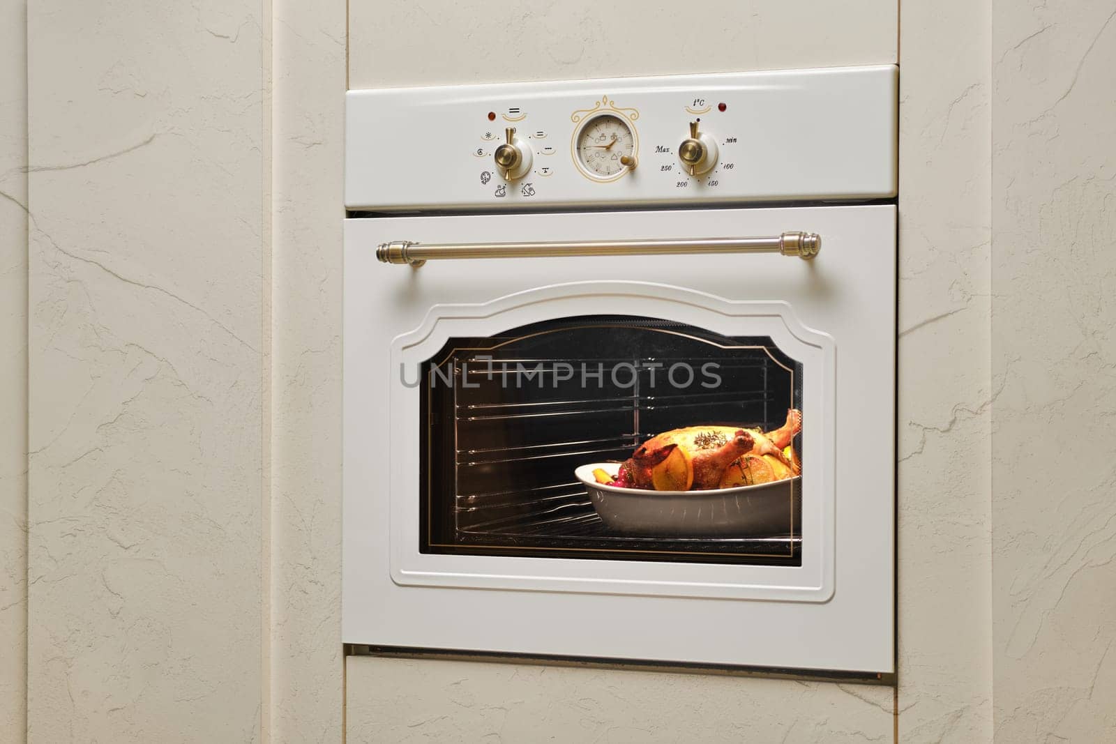 Process of baking food in oven. Whole chicken in ceramic casserole inside the oven.