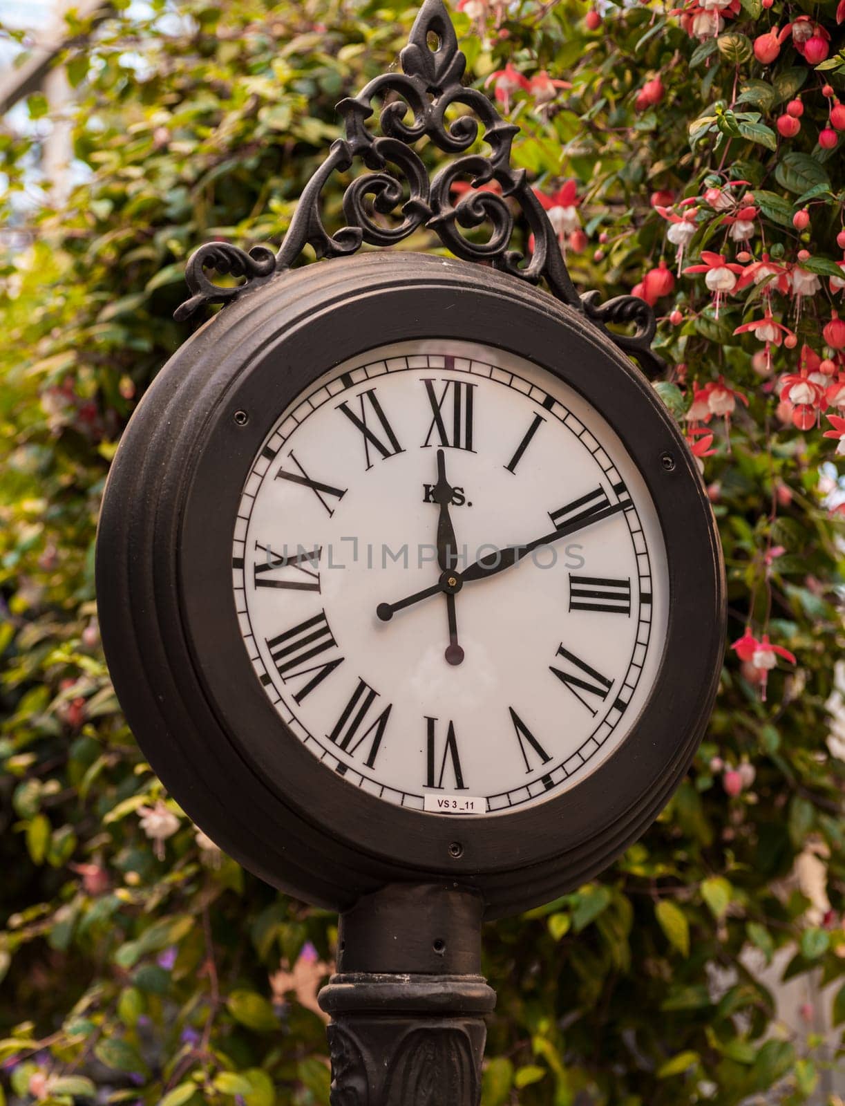 oldfashioned railway station clock pointing ten past noon