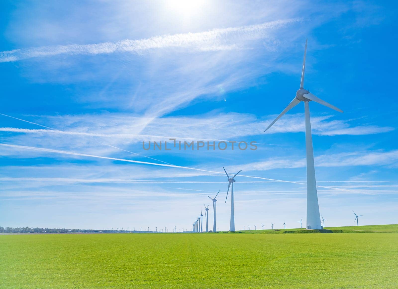 row of windmills in a flat dutch landscape