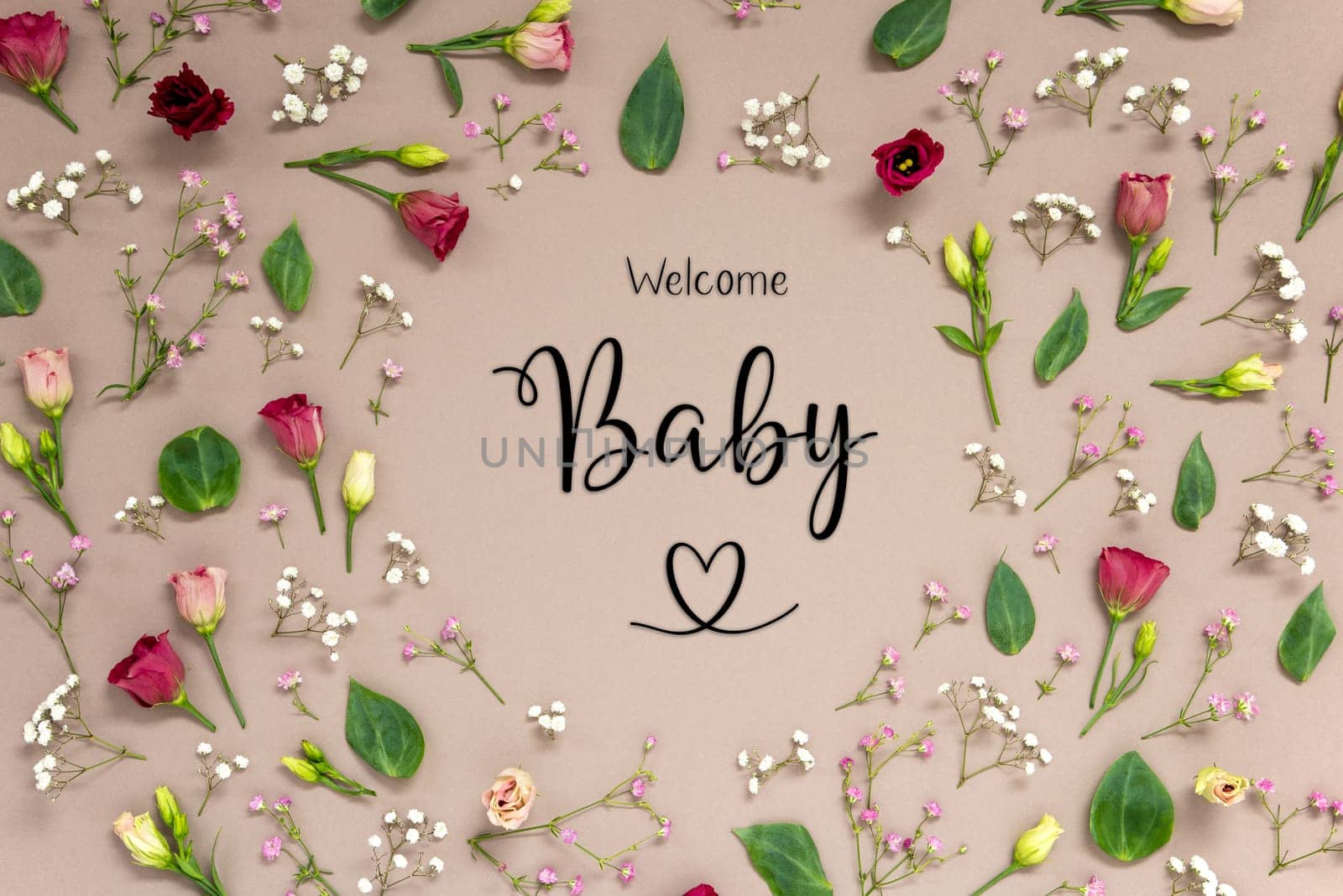 Flower Arrangement With English Text Welcome Baby. Colorful Spring Blossoms And Flowers Like Roses Building A Frame. Flat Lay With Brown Paper Background