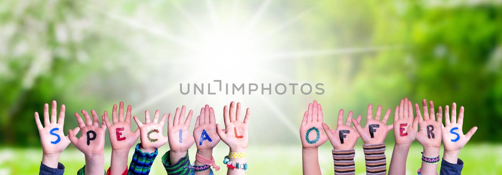 Children Hands Building Colorful English Word Special Offers. Sunny Green Grass Meadow As Background.