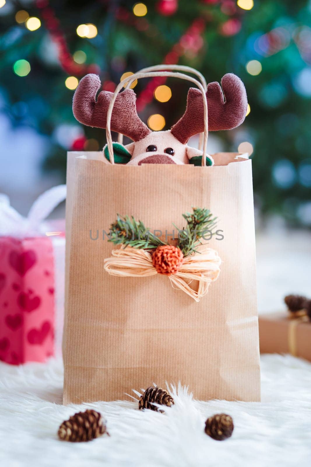 Reindeer toy in a paper bag for Christmas gift