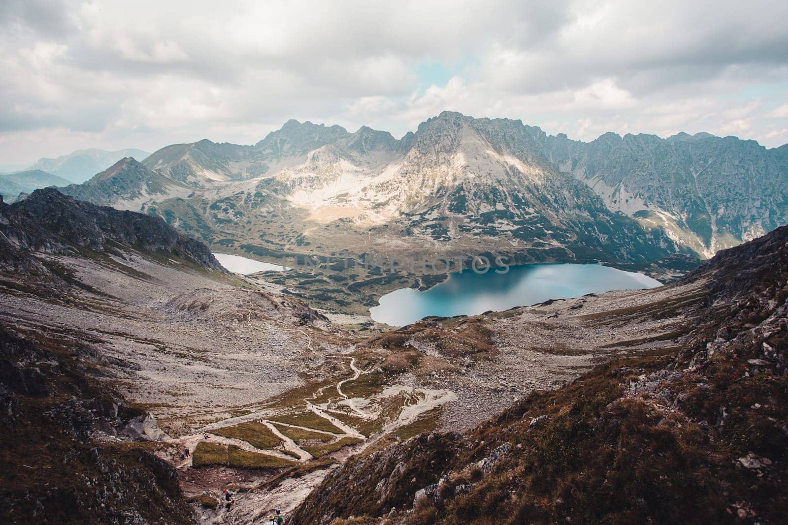 Landscape of mountain peaks, scenery from high summit on wide valley and lakes