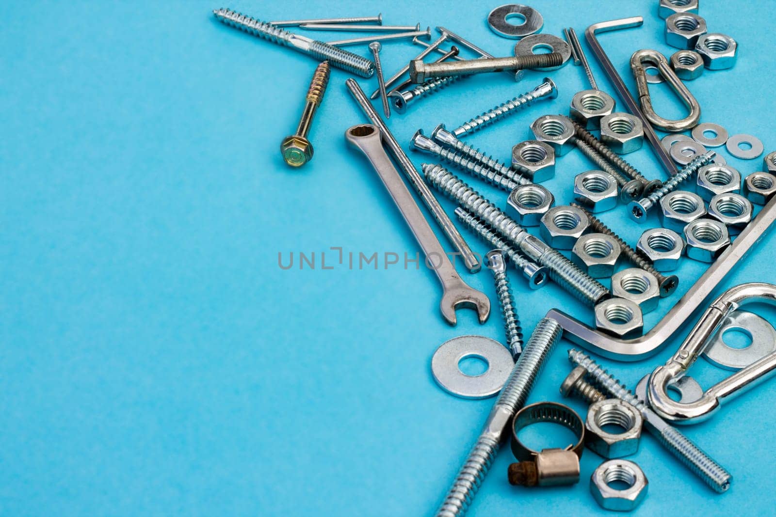 Bolts, nuts, wrenches and other construction tools on a blue background. Father's day concept. Copyspace