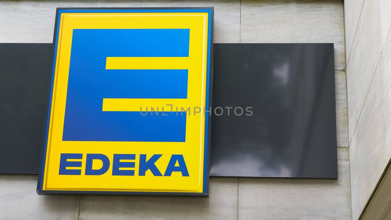 Illuminated sign of the German food discounter Edeka at a branch in Berlin