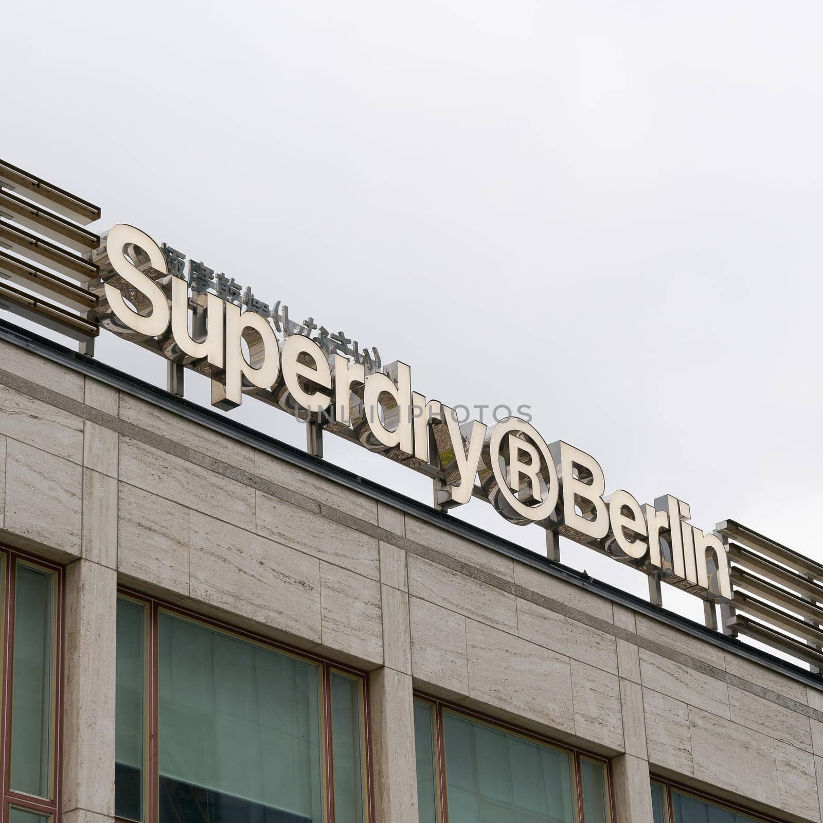 Company logo of the British textile chain Superdry on the roof of a store in Berlin
