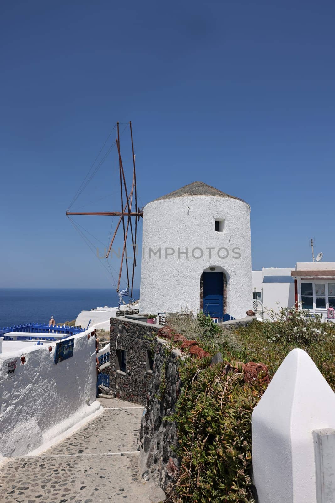 Traditional white windmill in Oia on the island of Santorini. Cyclades, Greece