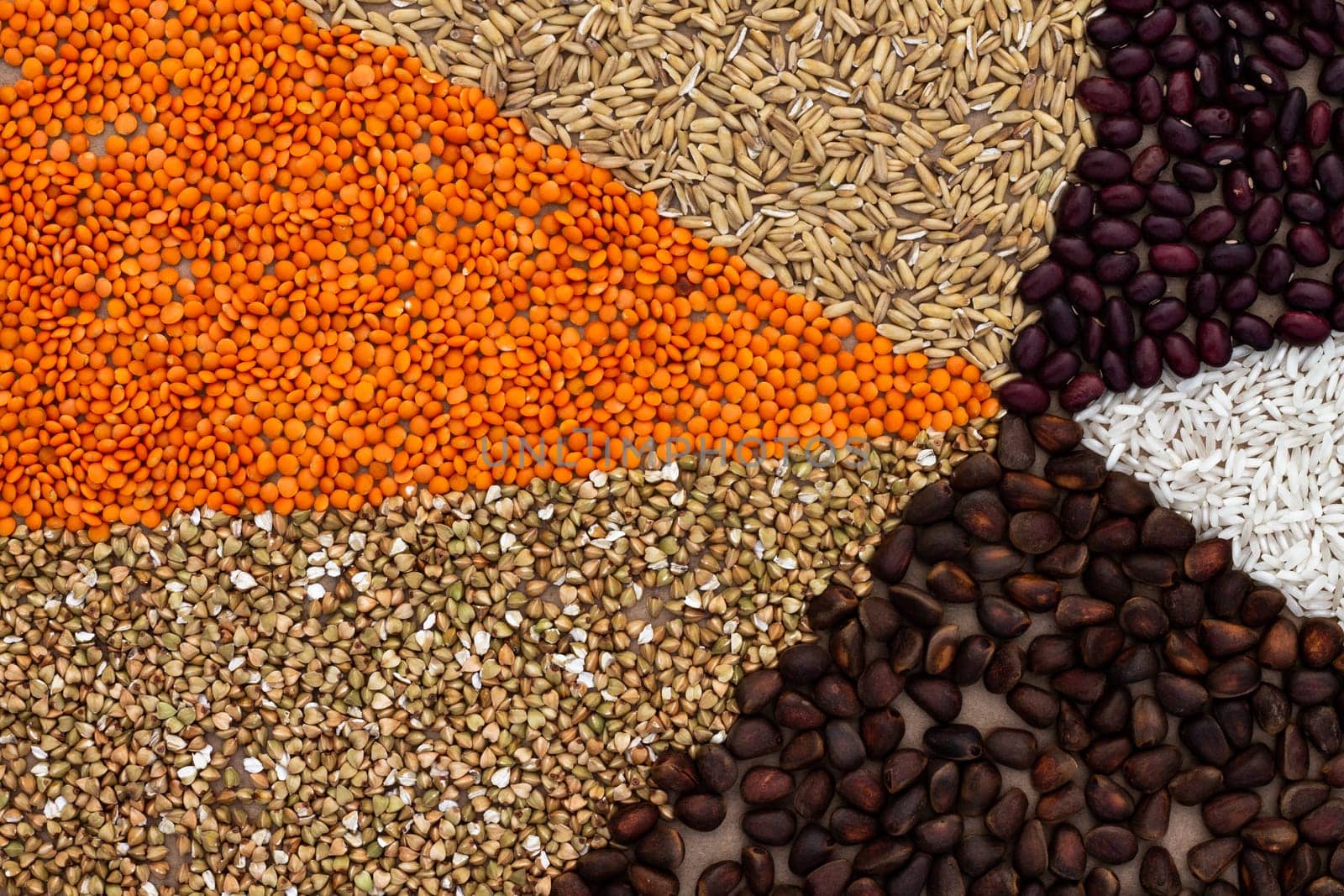 Background of triangles lined with various cereals and nuts on a craft paper