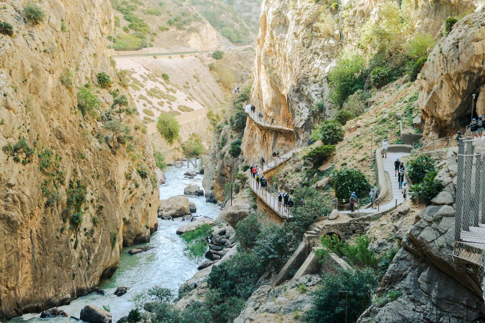 El Chorro, Spain, April 2023: People walking the Caminito Del Rey in the Desfiladero de los Gaitanes, a gorge carved by the Guadalhorce river in the province of Málaga, Spain