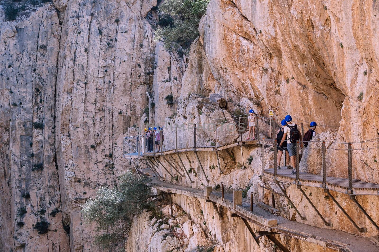 El Chorro, Spain, April 2023: People walking the Caminito Del Rey in the Desfiladero de los Gaitanes, a gorge carved by the Guadalhorce river in the province of Málaga, Spain