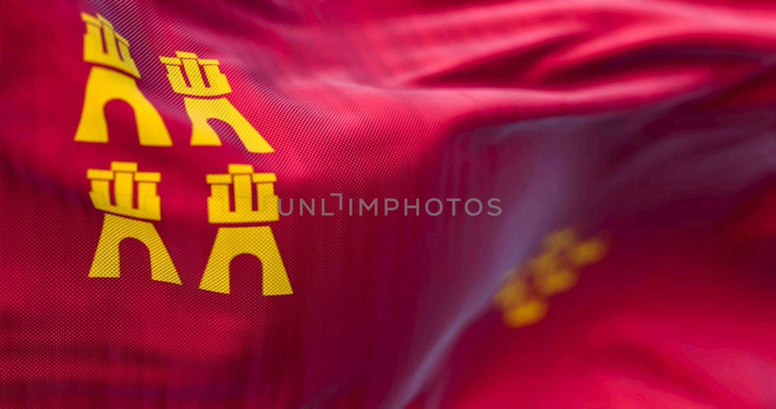 Detail of the Murcia flag waving. Autonomous community of Spain. Four castles and seven crowns on a crimson background. 3d illustration render. Selective focus. Close-up. Fluttering fabric