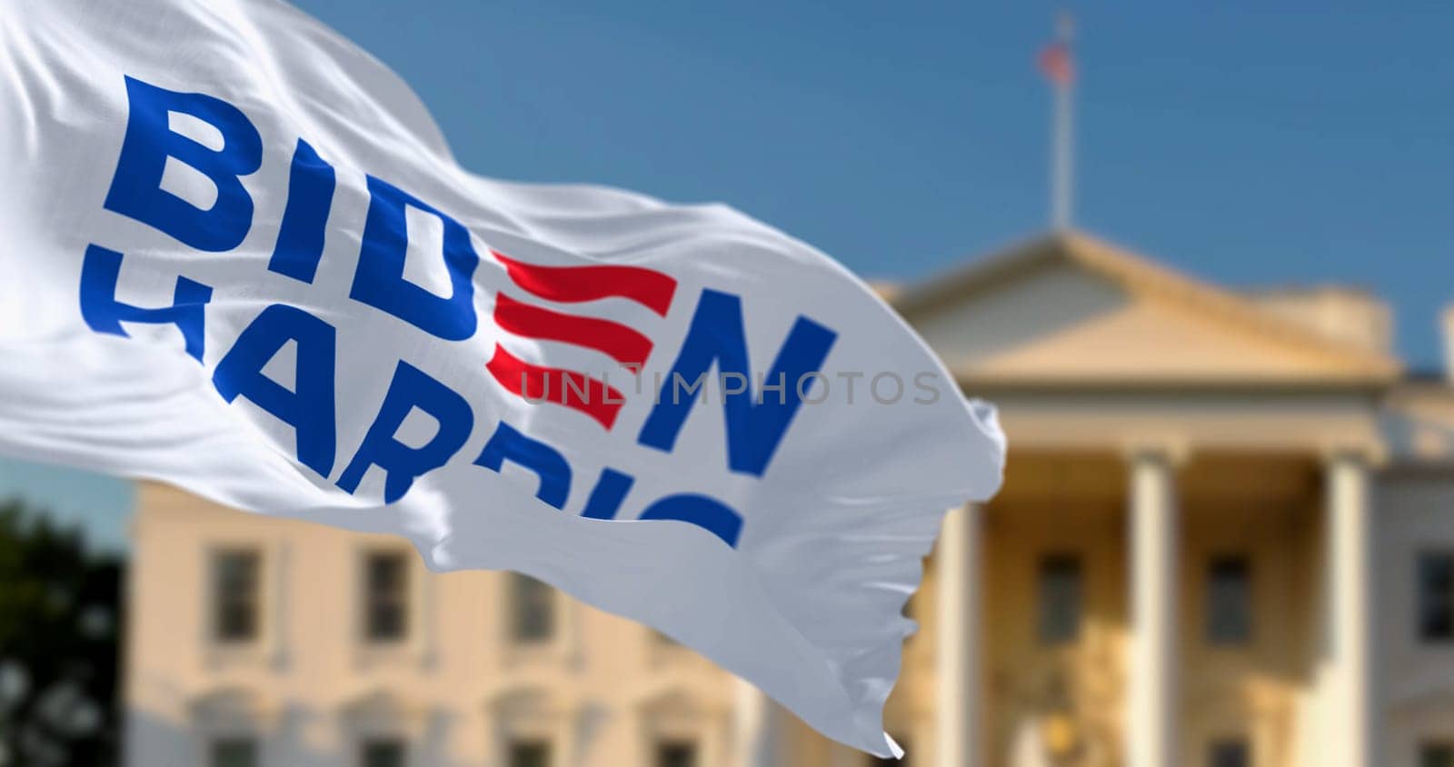 Washington D.C., US, april 2023: Flag with Biden Harris 2024 presidential election campaign logo waving in front a blurred White House. Illustrative editorial 3d illustration render