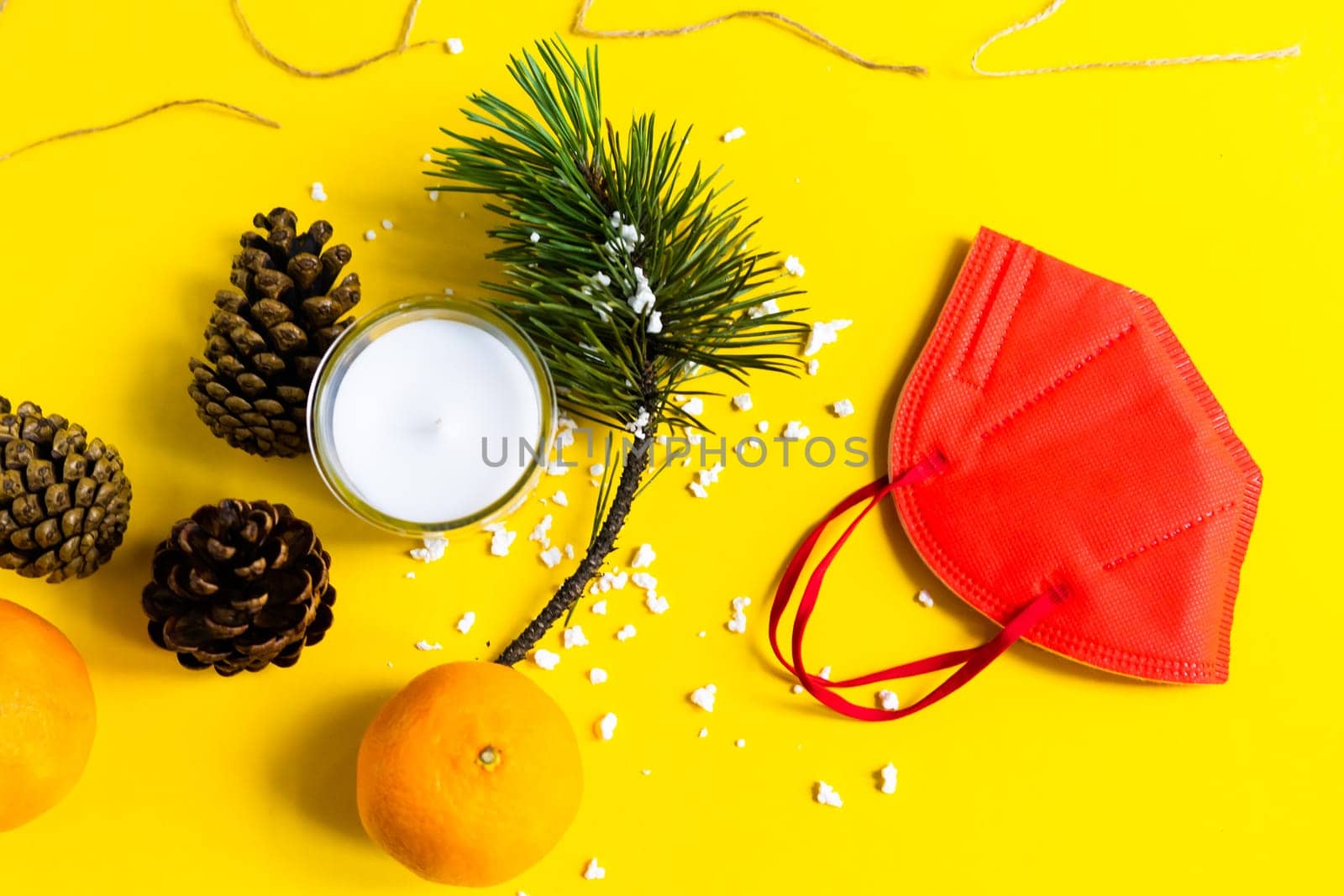 New Year's conceptual background. Christmas tangerines and medical mask. Plans for 2022