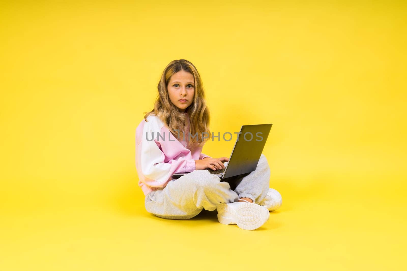 Funny little blonde kid girl 12-13 years old studio portrait. Childhood lifestyle conception
