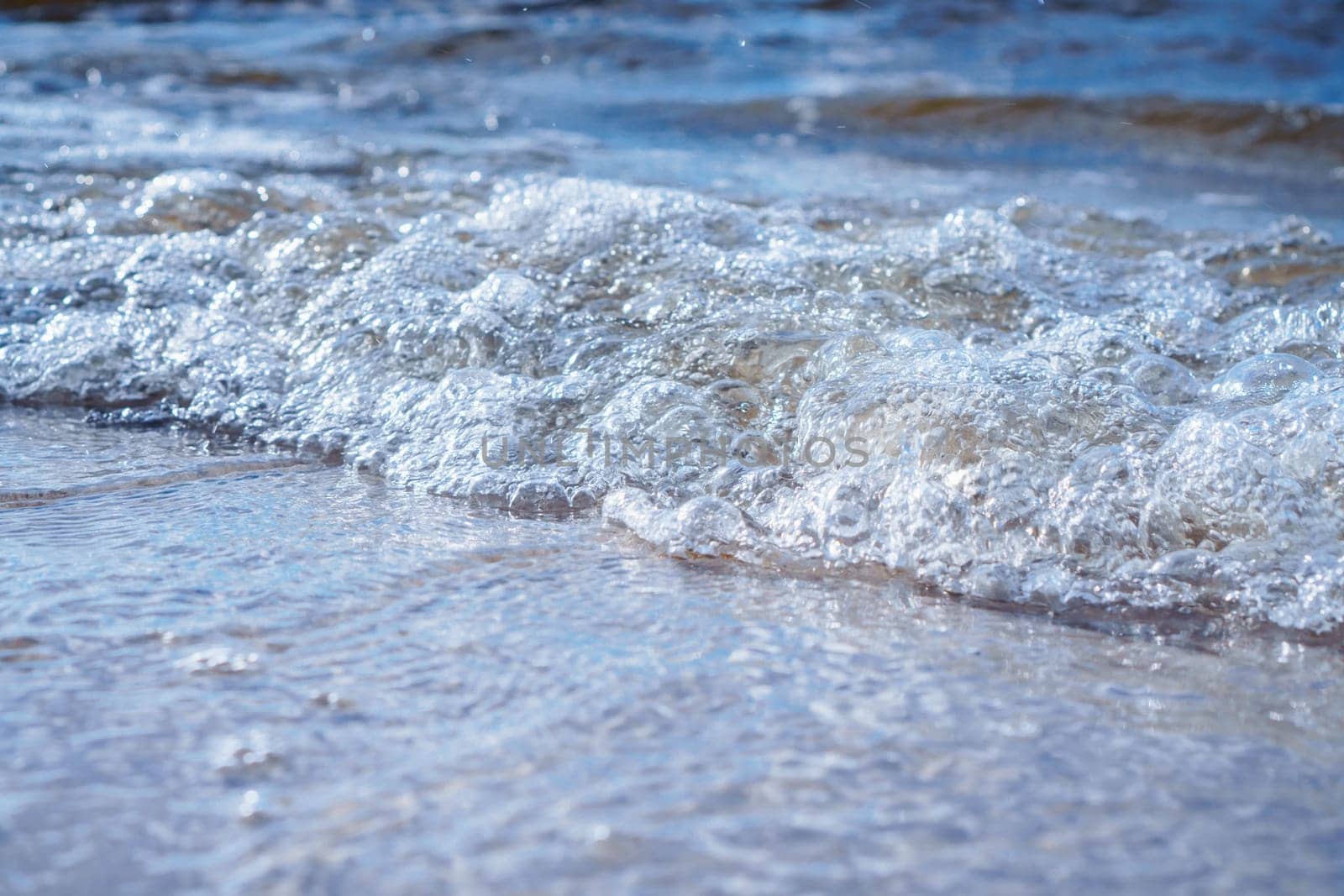 Close-up of pearl sea foam from incoming wave. Relaxation. Interior paintings. Wonderful moments of life. Tourism and travel. Splendor of nature. Rest and pleasure. Enjoying beautiful.