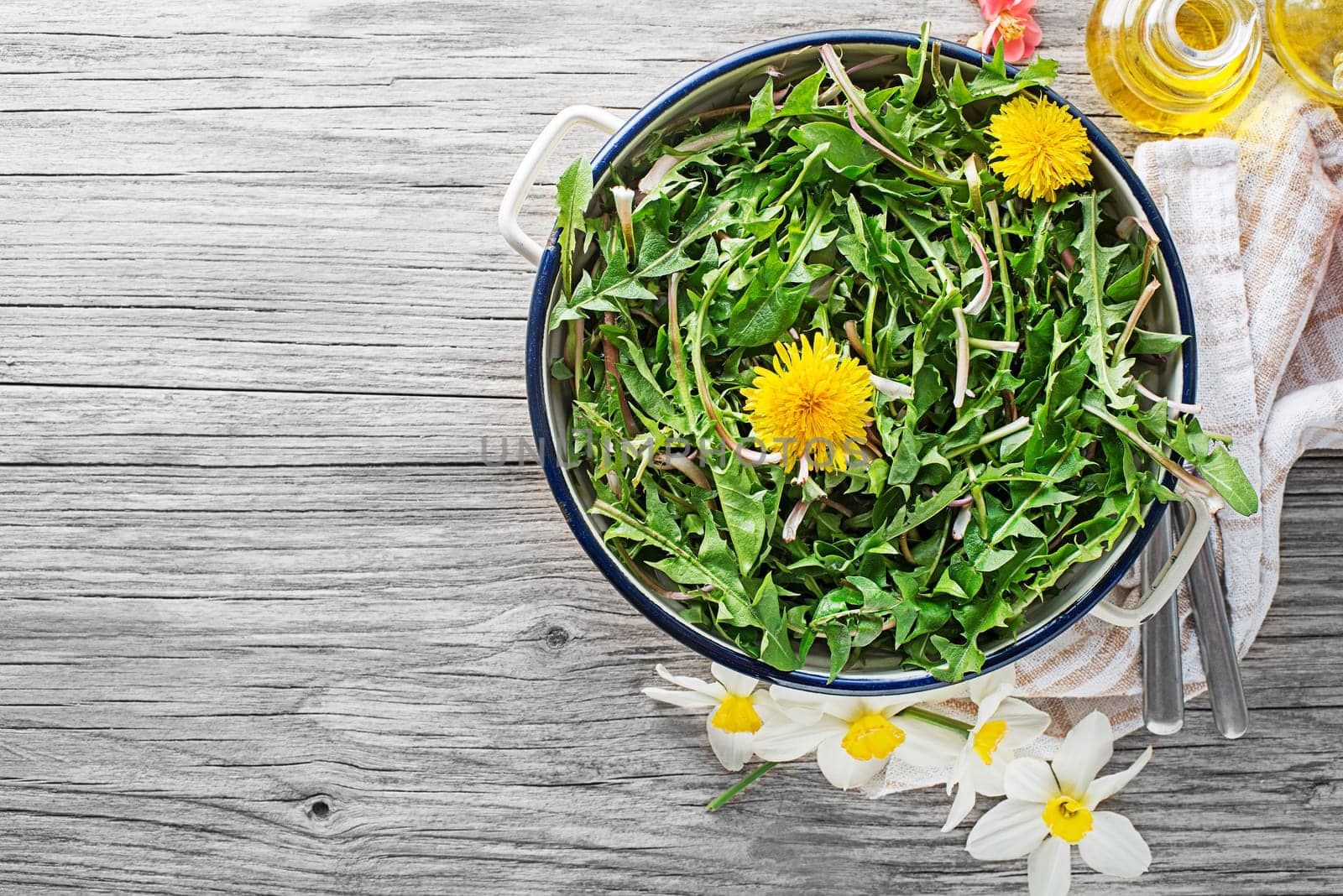Fresh dandelion salad with dressing. Healthy spring food concept
