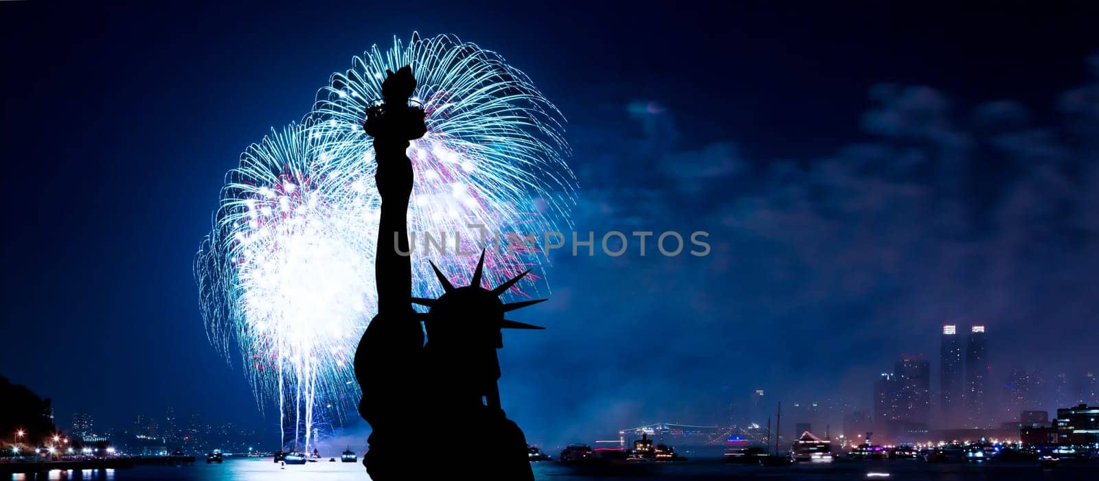 The silhouette of Statue of Liberty Statue of Liberty and July 4th fireworks over Hudson River