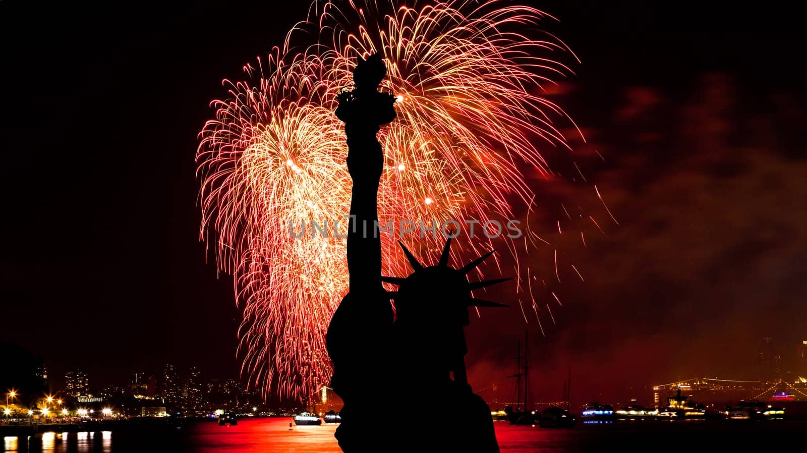 The silhouette of Statue of Liberty Statue of Liberty and July 4th fireworks over Hudson River