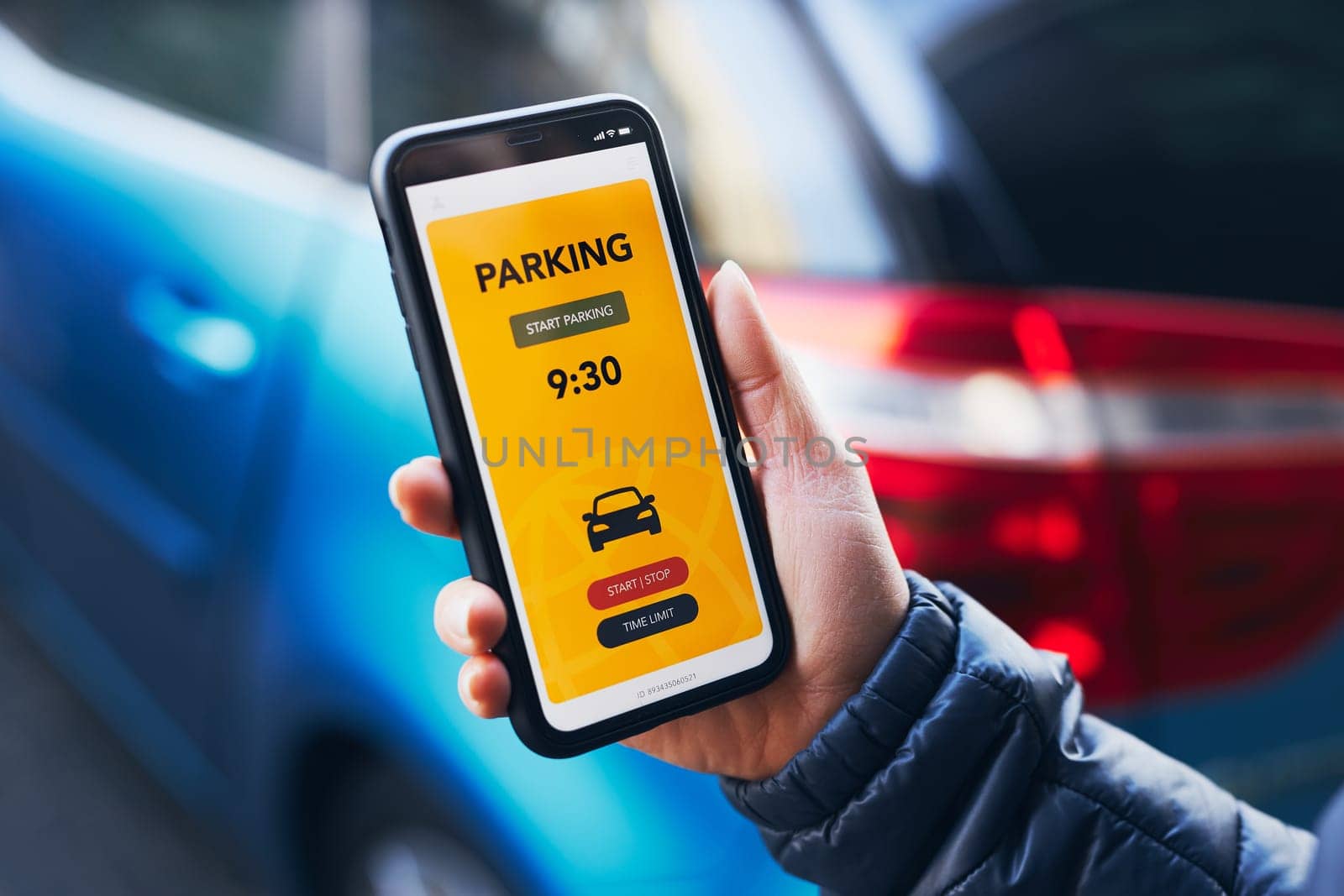 Woman using mobile parking app on smartphone. Driver using smartphone to pay for parking. Car park application on mobile phone. Convienience paying for parking using fast payment online. Mobile park service
