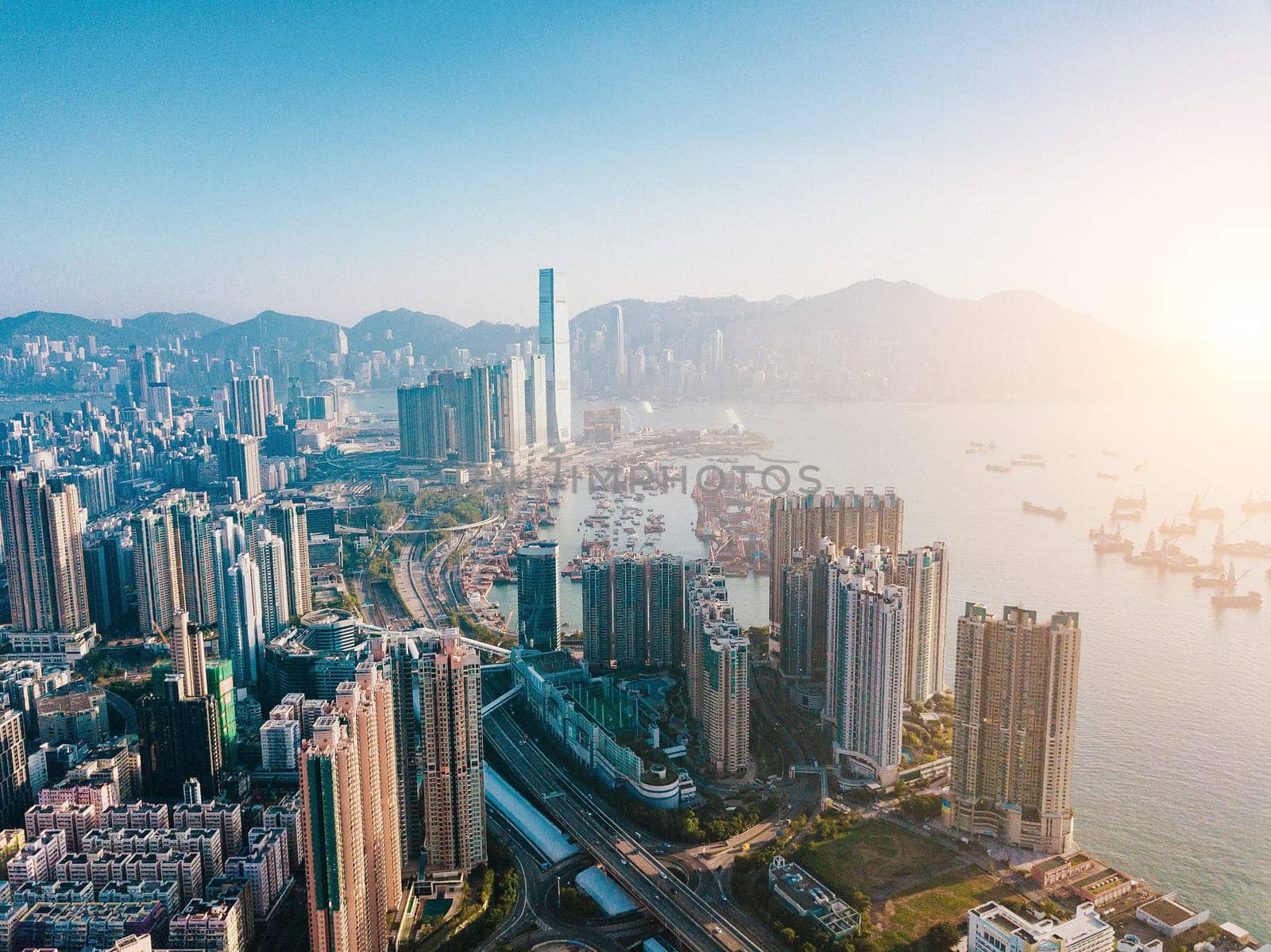 Top view aerial photo from flying drone of a developed Hong Kong city with modern skyscrapers with contemporary design. China town with business and financial centers and road with cars - Image