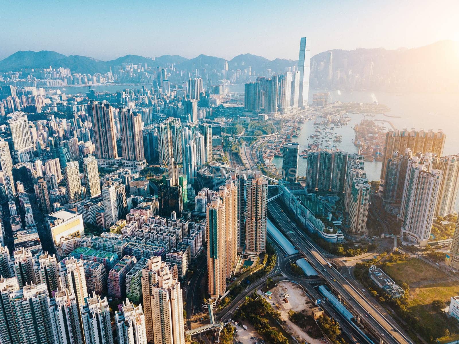 Top view aerial photo from flying drone of a developed Hong Kong city with modern skyscrapers with contemporary design. China town with business and financial centers and road with cars - Image