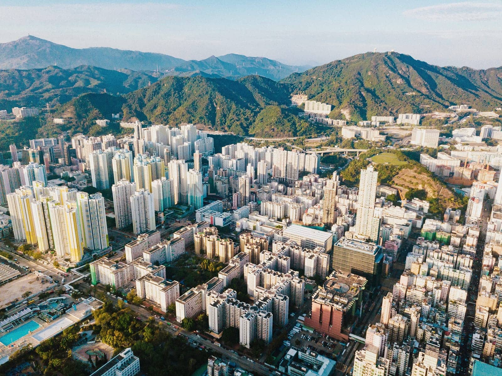 Top view aerial photo from flying drone of a developed Hong Kong city with modern skyscrapers with contemporary design. China town with business and financial centers and road with cars - Image