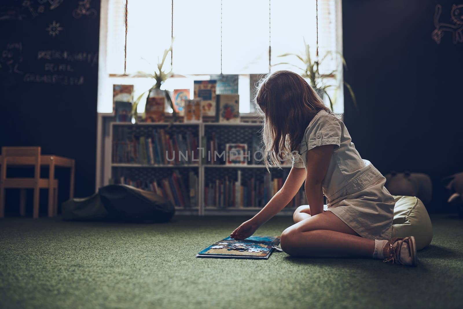 Child solving riddle in book in school library. Primary school pupil is involved in book with riddles. Smart girl learning to solve problems. Benefits of everyday practice. Child curiosity