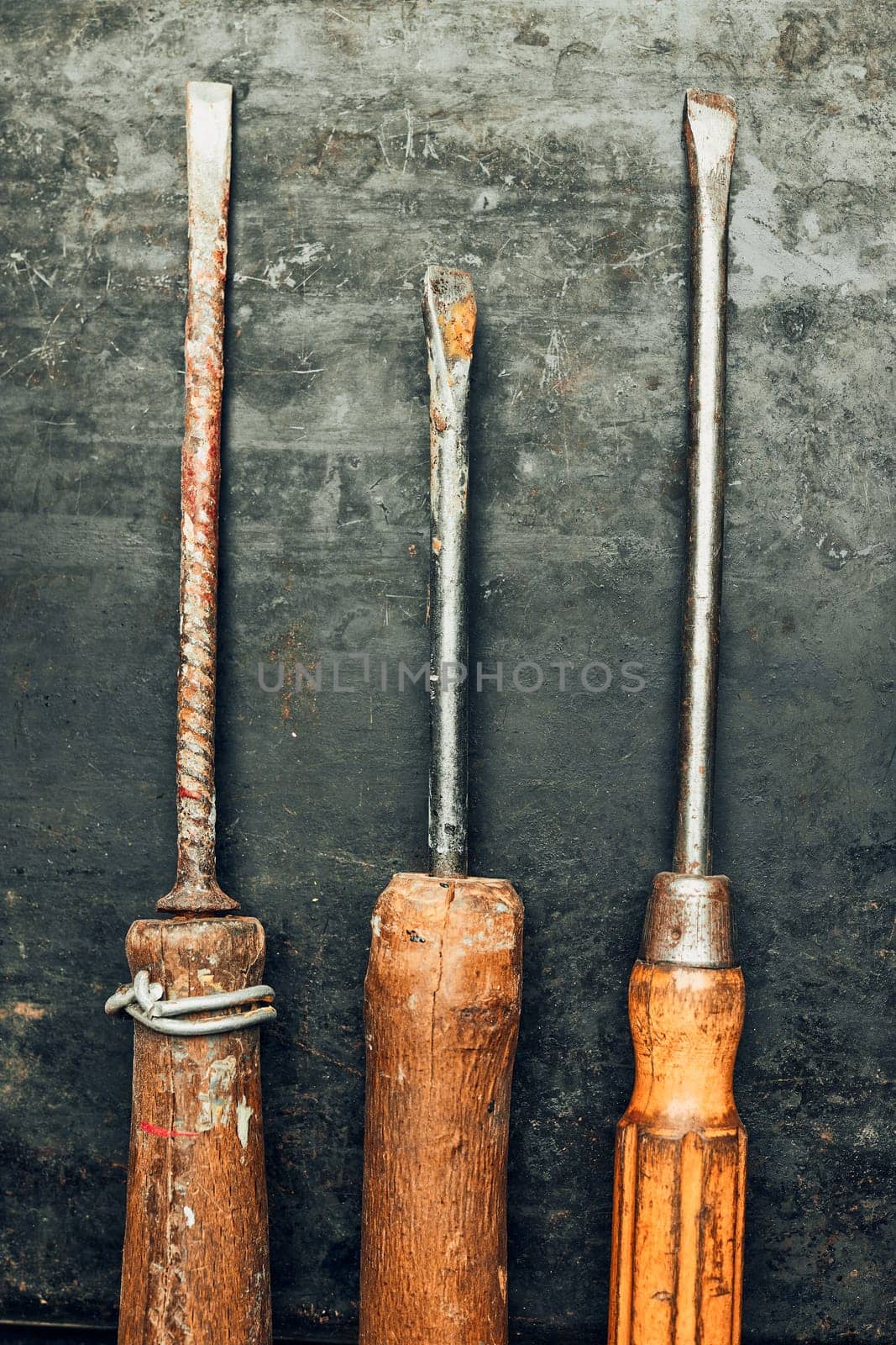 Screwdrivers. Set of old screwdrivers on steel surface. Mechanic tools for maintenance. Hardware tools to fix. Technical background with copy space