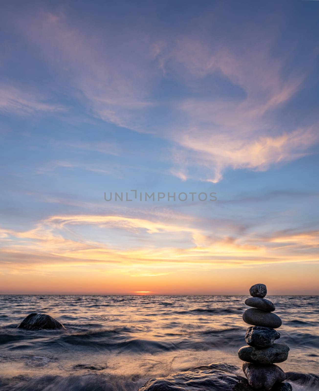 Stone pyramids and glass sphere on the dreamy Baltic Sea sand beach on Rügen for the spectacular sunset