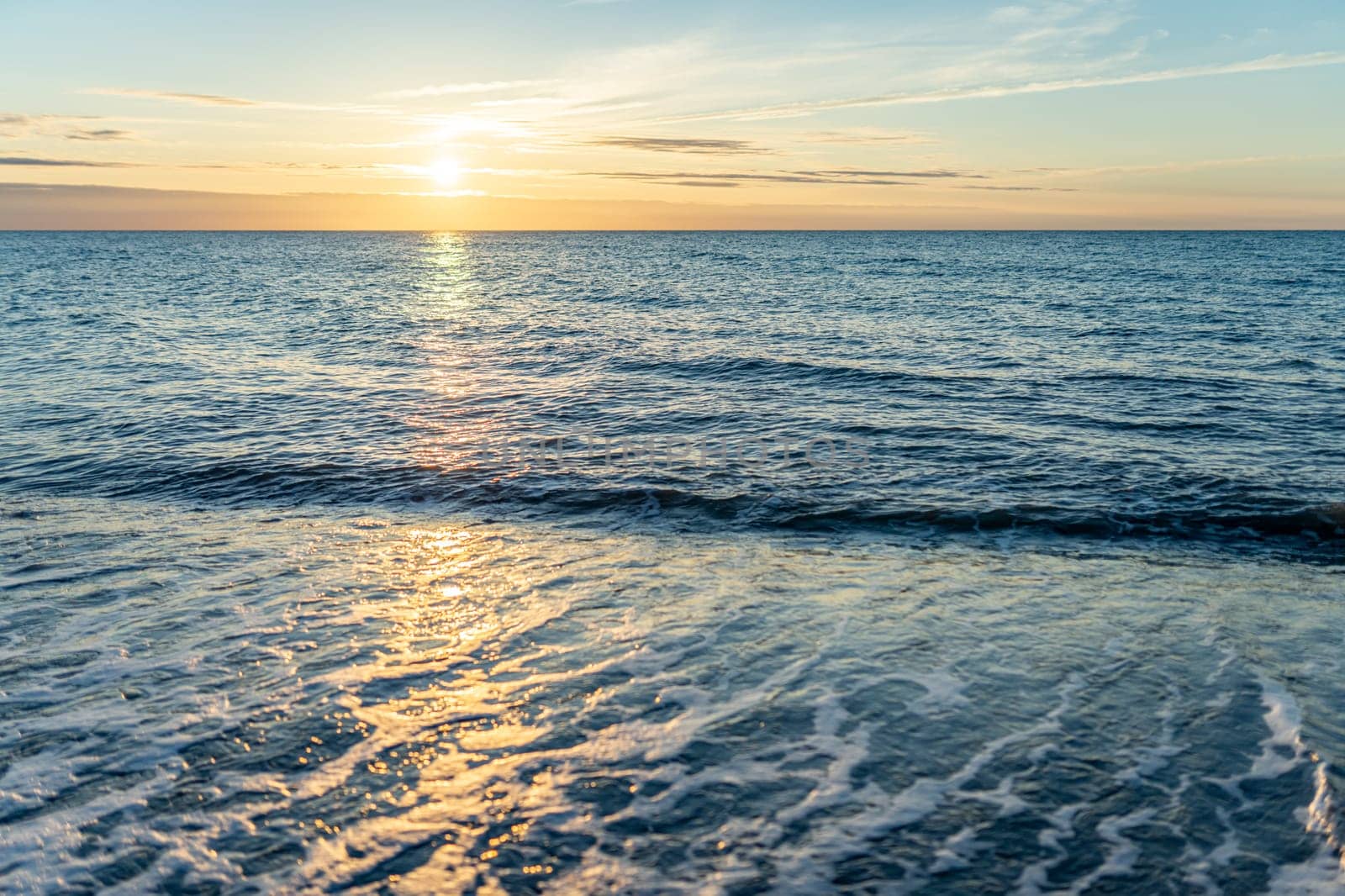 orange, sunset between rocks in the sea of the Baltic Sea near Dranske on the island of Rügen-	Beautiful sunset over the sea with waves and rocks in the foreground