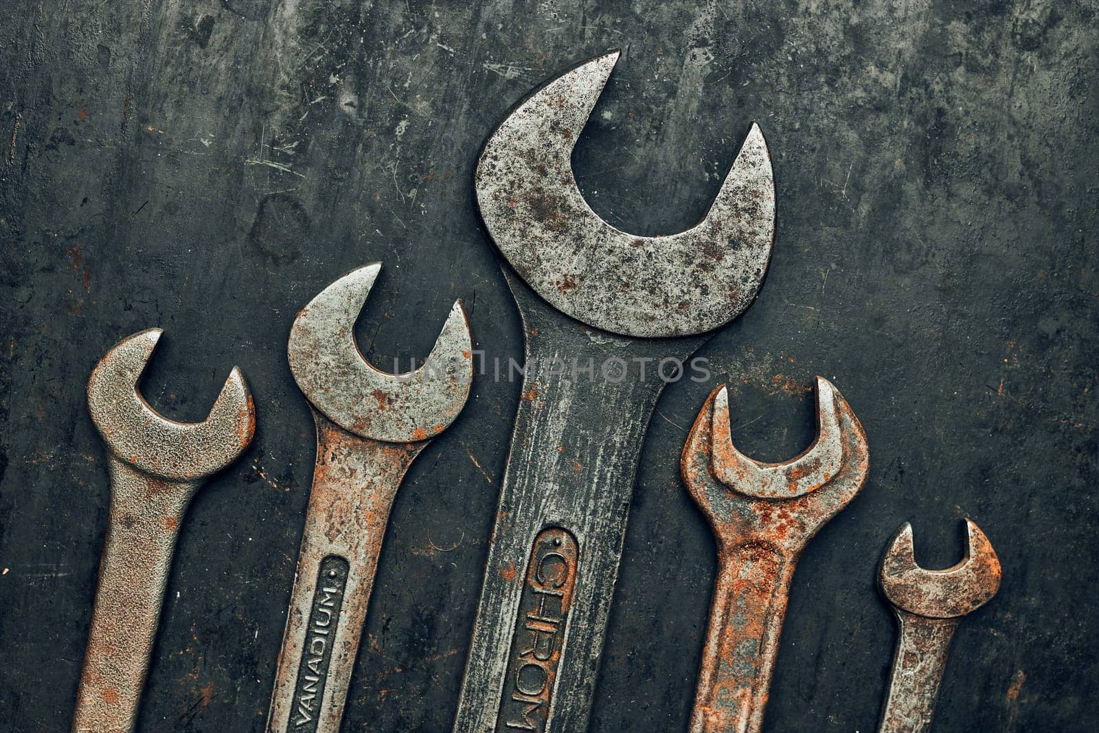 Spanners on steel surface. Old rusty wrenches for maintenance. Mechanic hardware tools to fix. Technical tools background with copy space