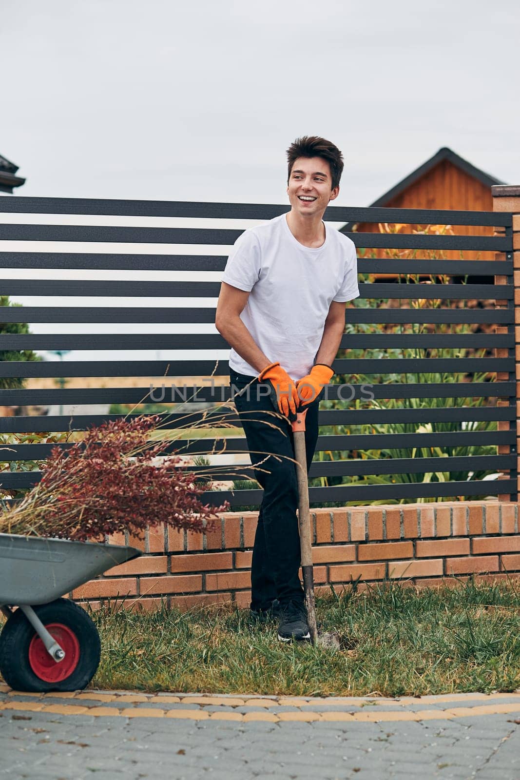 Teenage boy planting the plants, working at a home garden. Candid people, real moments, authentic situations