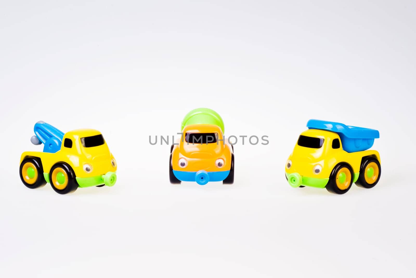 Little toy cars team on white background