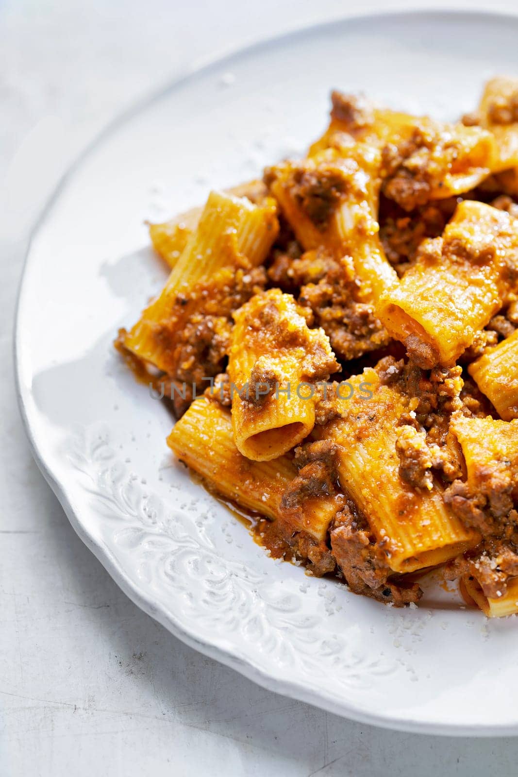 close up of a plate of rigatoni bolognese pasta comfort food